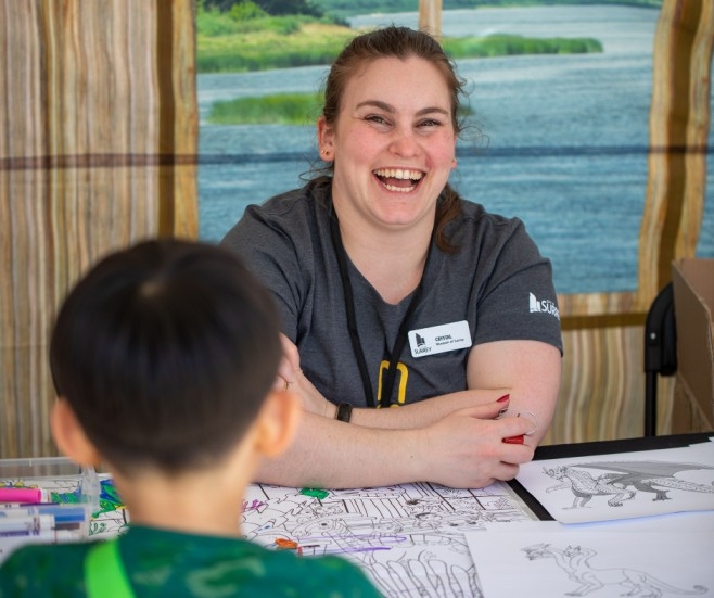 person smiling at party for the planet