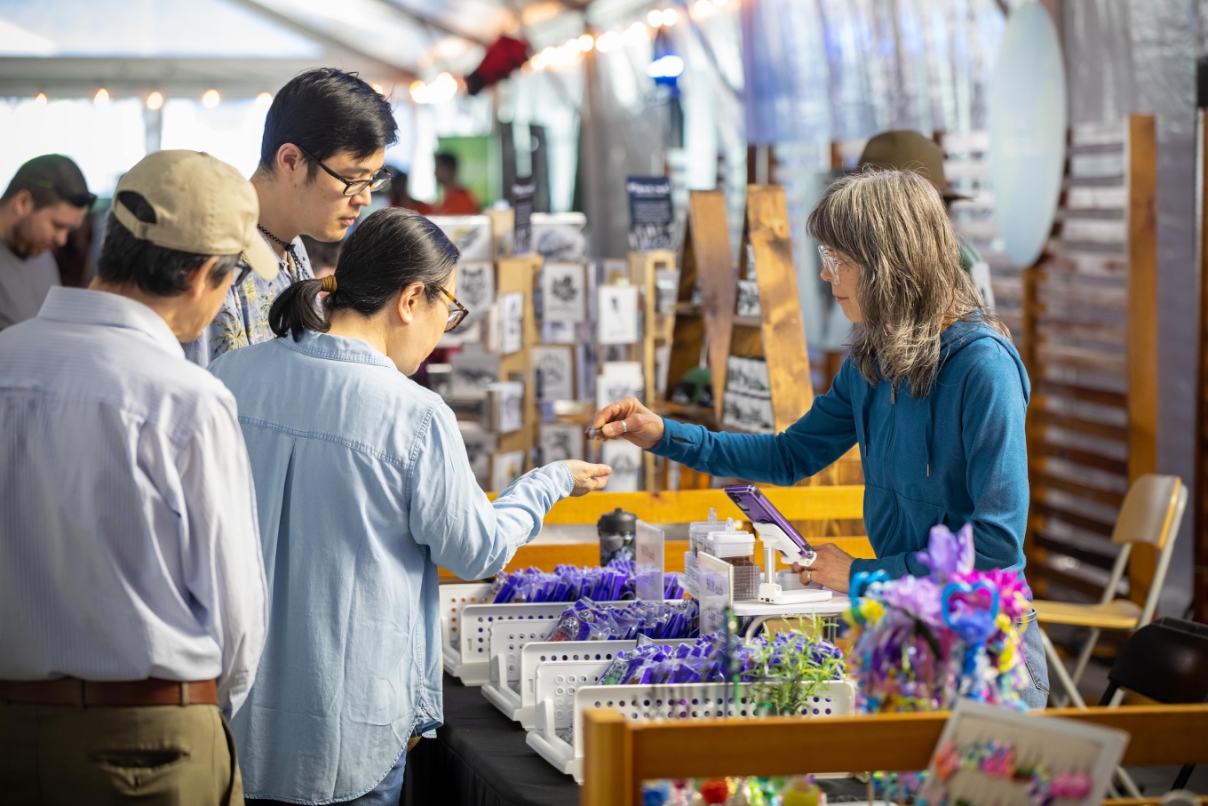 Market vendor talking to customers